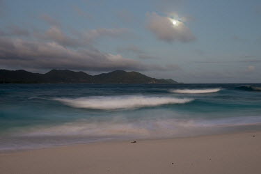 Indian Ocean and Praslin in moonlight Indian Ocean Islands,landscape,shore,waves,twilight,moonlight,moon,clouds
