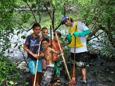 Youth volunteers helping clean a polluted mangrove mangrove,mangroves,coast,coastal,coastline,litter,pollution,human impact,plastic pollution,waste,tide,tidal,plastic,landscape,beach clean,clean,mangrove clean,tidy,youth,humans,people,protection,conse