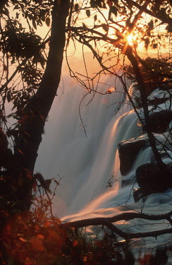 Victoria Falls at sunset, from Zambian side - Zambia Waterfall,Spectacular,Sunset,Sunbeam,Light,Mist,Spray,Landscape,Formation,Geological,Water,River,Cliff
