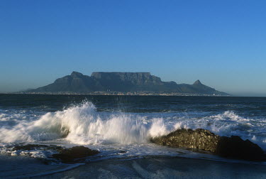 Coastal scene looking out at Table Mountain - Cape Town, South Africa Table Mountain,Coast,Coastal,Sea,Beach,Sand,Wave,Rocks