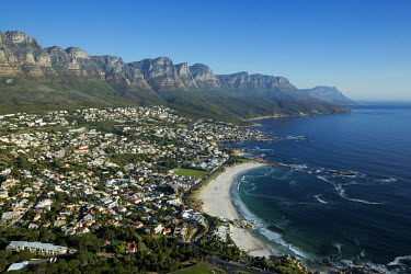 Aerial view of Camps Bay with the view of the Twelve Apostles mountain range - Cape Town, South Africa Coastal,Town,Beach,Sand,Mountain,Cliff,Settlement,Civilisation,Ocean,Sea,Bluesky