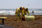 HAZMAT workers conduct a recovery of a barrel of unknown content on Galveston Island.
