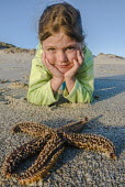 Child watching starfish on beach De Hoop Nature Reserve & Marine Protected Area,South Africa,Western Cape,photography,vertical,child,children