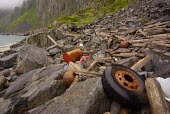 Marine debris on rocky shoreline in Troms Bo Eide sea,nature,trash,coast,debris,litter,coastline,environmental issues,marine debris,plastic waste,marine litter,plastic litter,strandline,wheel,driftwood,drum