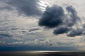 Sunlight dappling North Atlantic Ocean seascape,landscape,cloudscape,cloud,clouds,sea,dark clouds,ray,rays,sun rays,sunlight,dapple,dappled,North Atlantic Ocean,Atlantic ocean,ocean,marine,horizon,grey,greys,gray,grays