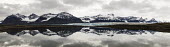 Sveabreen on Svalbard surrounded with mountains and their reflections. Svalbard,panorama,panoramic,glacier,glacial,mountains,snow,coast,water,reflection,reflections,calm,flat,clouds,Arctic,Spitsbergen,Clouds,Glacier,Mountains,Reflection