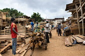 A wood seller at MonteÌe Parc Market africa,people,man,men,horizontal,timber,market,markets,commercial,cameroon,yaounde,wood market,seller,work,wood,deforestation