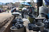 Charcoal seller at Mokolo Market africa,market,markets,charcoal,coal,seller,cameroon,yaounde,livelihoods,biofuel,charcoal seller,Mokolo,trade,deforestation,cooking,energy,Yaounde,Cameroon,buckets,shallow focus,people,low angle,stree