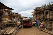 A wood seller at MonteÌe Parc Market africa,people,man,men,horizontal,timber,market,markets,commercial,cameroon,yaounde,wood market,seller,work,wood,lumber,deforestation