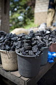 Charcoal seller at Mokolo Market africa,market,markets,charcoal,coal,seller,cameroon,yaounde,livelihoods,biofuel,charcoal seller,Mokolo,trade,deforestation,cooking,energy,YaoundeÌ,Cameroon,buckets,shallow focus