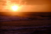Sunset from a Costa Rican beach sunset,dusk,sundown,sea,ocean,oceans,seas,beach,coast,coastal,shore,tide,waves,wave,surf,seascape,horizon,sun,sky,orange,water,Americas,Central America,Costa Rica,tropical,tropics,Spanish,rainforest