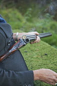 A well dressed female hunter holding her shotgun during a pheasant shoot hunting,hunt,gun,guns,violence,violent,skill,enjoyment,recreational sport