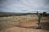 A researcher using telemetry to locate radio-collared lynx researcher,research,tracking,conservation,science,field work,lynx,Iberian lynx,humans,people,telemetry,radio tracking,antenna