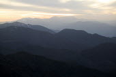 View of the high Atlas mountains ecosystem,habitat,environment,landscape,Morocco,Africa,mountains,sunset,sundown,dusk,silhouettes,hazy,mountain range,hills,altitude