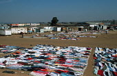 Clothes laid out for sale in informal settlement/slum area - Johannesburg, South Africa Informal settlement,Improvisation,Roofs,Rooftops,Colourful,Environment,Outside,Clothes,Sale,Market,Fabric,Subsistence