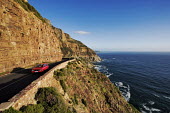 Aerial view of Chapmanâs Peak Drive, steep cliffs fall into the Atlantic Ocean right next to the scenic drive - Western Cape Province, South Africa Coast,Road,Winding,Car,Rocky,Cliff,Mountain,Hills,Ocean,Sea