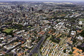 Aerial view of central Johannesburg - South Africa Aerial,Landscape,City,Road,Buildings,Houses,Neighbourhood,Trees,Rooftops,Settlement,Tree-lined,Colourful,Purple,Colour,City centre,Skyline,Highway,Main road