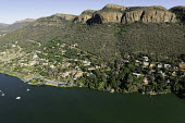 Riverside town backed by high ridges - South Africa Aerial,Riverside,Town,Mountains,Settlement,Slope,River,Boats,Trees