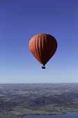 Red hot air balloon rises over mountain ranges and a lake - South Africa Hot-air balloon,Lake,Flying,Ride,Calm,Blue sky,Clear sky,Mountains,Entertainment,Activity,Excursion,View,Red
