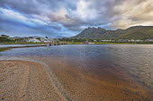 Small town of Betty's Bay under a dramatic sky - Western Cape province, South Africa Bay,Coastal,Coast,Mountain,Dramatic sky,Sky,Cloud formation,Blue,Sand,Landscape