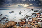 Dramatic clouds over a rocky bay, long exposure - South Africa. Beauty in nature,Rocky shore,Stones,Pebbles,Coastal,Coast,Sea,Ocean,Long exposure,Cloud formation,Dramatic sky