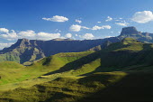 The Amphitheatre mountain formation rises straight up to the sky to over 3000 feet - South Africa Africa,African,Southern Africa,scenic,scenery,beauty in nature,natural world,non-urban scene,nature,outdoors,sky,cloud formation,blue sky,mountains,landscape,green,grass,imposing,amphitheatre