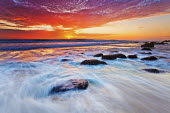 A colourful sun set over the Atlantic ocean at Betty's Bay - South Africa Beauty in nature,Sunset,Dramatic sky,Colour,Long exposure,Coast,Coastal,Waves,Rocks,Boulders,Clouds,Orange,Red,Blue