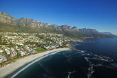 Aerial view of Camps Bay with the view of the Twelve Apostles mountain range - Cape Town, South Africa Aerial,Coastal,Town,Beach,Sand,Mountain,Cliff,Settlement,Civilisation,Ocean,Sea,Bluesky,Rock formation